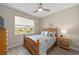 Comfortable bedroom featuring a ceiling fan, light gray walls, laminate flooring, and lots of natural light at 8874 Sw 104Th Cir, Ocala, FL 34481