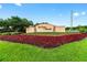 Community entrance sign with lush landscaping and colorful flowers at 8874 Sw 104Th Cir, Ocala, FL 34481