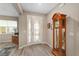 Inviting foyer with stylish floors, a decorative clock, and glass paneled door for plenty of natural light at 8874 Sw 104Th Cir, Ocala, FL 34481