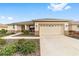 Welcoming home with a spacious two-car garage, complemented by a charming front porch and lush landscaping at 8874 Sw 104Th Cir, Ocala, FL 34481