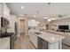 Open-concept kitchen with stainless appliances, stone countertops, and direct view into the living room at 8874 Sw 104Th Cir, Ocala, FL 34481