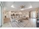 Open-concept living room with stylish furniture, an area rug, and a view of the adjacent kitchen at 8874 Sw 104Th Cir, Ocala, FL 34481