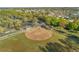 Aerial view of the community ball field, showcasing its well-maintained grounds and proximity to residential area at 9033 Se 136Th Loop, Summerfield, FL 34491