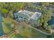 Aerial shot of the community clubhouse with mature trees, surrounding landscaping and water feature at 9033 Se 136Th Loop, Summerfield, FL 34491