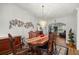 Formal dining room with a decorative chandelier and intricate wood furnishings at 9033 Se 136Th Loop, Summerfield, FL 34491