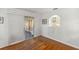 Dining room with wood floors, sliding door and a passthrough to the kitchen at 9033 Se 136Th Loop, Summerfield, FL 34491