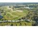 Scenic overhead view of the golf course, showcasing the lush fairways and manicured greens at 9033 Se 136Th Loop, Summerfield, FL 34491