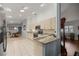 Well-lit kitchen featuring granite countertops, stainless appliances, white cabinetry, and tile flooring at 9033 Se 136Th Loop, Summerfield, FL 34491