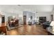 Open-concept living area with hardwood floors connecting the living and dining spaces at 9033 Se 136Th Loop, Summerfield, FL 34491