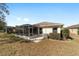 View of home with screened patio and well-maintained yard at 9126 Sw 102Nd Cir, Ocala, FL 34481