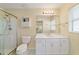 Well-lit bathroom with a shower, white vanity with marble top, and a large mirror at 9126 Sw 102Nd Cir, Ocala, FL 34481