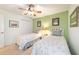 Bright bedroom with twin beds, a ceiling fan, and closet with soft natural green colors at 9126 Sw 102Nd Cir, Ocala, FL 34481