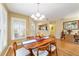 Bright dining room features hardwood floors, modern lighting, and ample natural light from a large window at 9126 Sw 102Nd Cir, Ocala, FL 34481