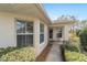 Welcoming home exterior with large windows and a neatly landscaped walkway leading to the front door at 9126 Sw 102Nd Cir, Ocala, FL 34481