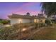 Exterior home view at dusk with lush landscaping and inviting curb appeal at 9126 Sw 102Nd Cir, Ocala, FL 34481