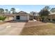 Charming single-story home featuring a well-maintained lawn, a two car garage, and an inviting facade at 9126 Sw 102Nd Cir, Ocala, FL 34481