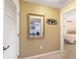 Hallway view with mirror showing living room, features a picture collage and access to the bedroom at 9126 Sw 102Nd Cir, Ocala, FL 34481