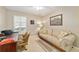 Cozy living room area with sofa, desk, and natural lighting with neutral earth-toned decor at 9126 Sw 102Nd Cir, Ocala, FL 34481