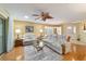 Spacious living room featuring hardwood floors, natural lighting, and seamlessly connecting living spaces for entertainment at 9126 Sw 102Nd Cir, Ocala, FL 34481