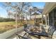 Covered patio features an outdoor dining set with seating and views of the wooded backyard at 9126 Sw 102Nd Cir, Ocala, FL 34481