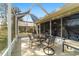 Screened-in patio featuring an outdoor dining area and comfortable seating at 9126 Sw 102Nd Cir, Ocala, FL 34481