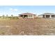 View of the rear of the home with a large backyard, showcasing the home's exterior, patio, and landscaping at 9399 Sw 106Th Ave, Ocala, FL 34481