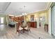 Bright dining area with a glass table, wicker chairs and chandelier, adjacent to the kitchen with granite counters at 9399 Sw 106Th Ave, Ocala, FL 34481