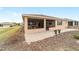 Exterior view of the house featuring a screened-in porch, paver patio, and landscaped yard at 9399 Sw 106Th Ave, Ocala, FL 34481