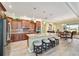 Bright kitchen area with bar stool seating and view of the dining area with wicker chairs at 9399 Sw 106Th Ave, Ocala, FL 34481