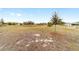 Wide-open lot view with immature landscaping, sparse grass and distant neighboring houses at 9399 Sw 106Th Ave, Ocala, FL 34481