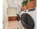 This is a laundry room with an included sink, washer and dryer and beautiful wood cabinets at 9399 Sw 106Th Ave, Ocala, FL 34481