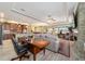 Open-concept living room flows into the kitchen and dining area, with a stone fireplace and wood-look floors at 9399 Sw 106Th Ave, Ocala, FL 34481