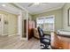 Home office with natural light, shutters, wood look flooring, and French doors at 9399 Sw 106Th Ave, Ocala, FL 34481