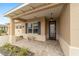 Welcoming covered porch features decorative shutters, a stone bench, and an elegant front door at 9399 Sw 106Th Ave, Ocala, FL 34481