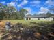 Serene backyard featuring well-maintained green lawn and surrounding trees at 96 Fisher Way Trl, Ocklawaha, FL 32179