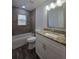 Bathroom with a tub, granite-topped vanity, and contemporary fixtures at 96 Fisher Way Trl, Ocklawaha, FL 32179