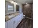 Bathroom featuring a double vanity, granite countertops and a tiled walk-in shower at 96 Fisher Way Trl, Ocklawaha, FL 32179