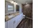 Stylish bathroom featuring a double vanity, granite countertop, and walk-in tiled shower at 96 Fisher Way Trl, Ocklawaha, FL 32179