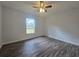 Bedroom with wood-look flooring, ceiling fan, and a window providing natural light at 96 Fisher Way Trl, Ocklawaha, FL 32179