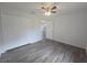 Bedroom featuring wood-look flooring, a ceiling fan, and a closet for storage at 96 Fisher Way Trl, Ocklawaha, FL 32179