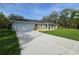 Charming home featuring a front-facing garage and a well-manicured lawn at 96 Fisher Way Trl, Ocklawaha, FL 32179