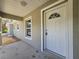 Close up of the front door showing a half-round window and a secure door lock at 96 Fisher Way Trl, Ocklawaha, FL 32179