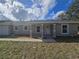 Charming single-story home featuring a covered porch, white trim, and a well-manicured lawn at 96 Fisher Way Trl, Ocklawaha, FL 32179