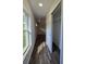 Hallway boasts wood-look flooring, natural light, and closet space at 96 Fisher Way Trl, Ocklawaha, FL 32179