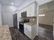 A well-equipped kitchen features white cabinets, granite countertops, and stainless steel appliances at 96 Fisher Way Trl, Ocklawaha, FL 32179