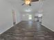 Open-concept living room featuring wood-look floors and a seamless flow to the kitchen at 96 Fisher Way Trl, Ocklawaha, FL 32179