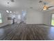 Open concept living and dining area with modern lighting and wood-look flooring at 96 Fisher Way Trl, Ocklawaha, FL 32179