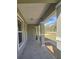 View from covered front porch showing painted support columns and an exterior view at 96 Fisher Way Trl, Ocklawaha, FL 32179