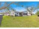 Spacious backyard featuring a well-manicured lawn and mature trees at 9661 Se 173Rd Pl, Summerfield, FL 34491