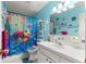 Bright bathroom features white vanity, white tile floors, and playful turtle themed decorations at 9661 Se 173Rd Pl, Summerfield, FL 34491